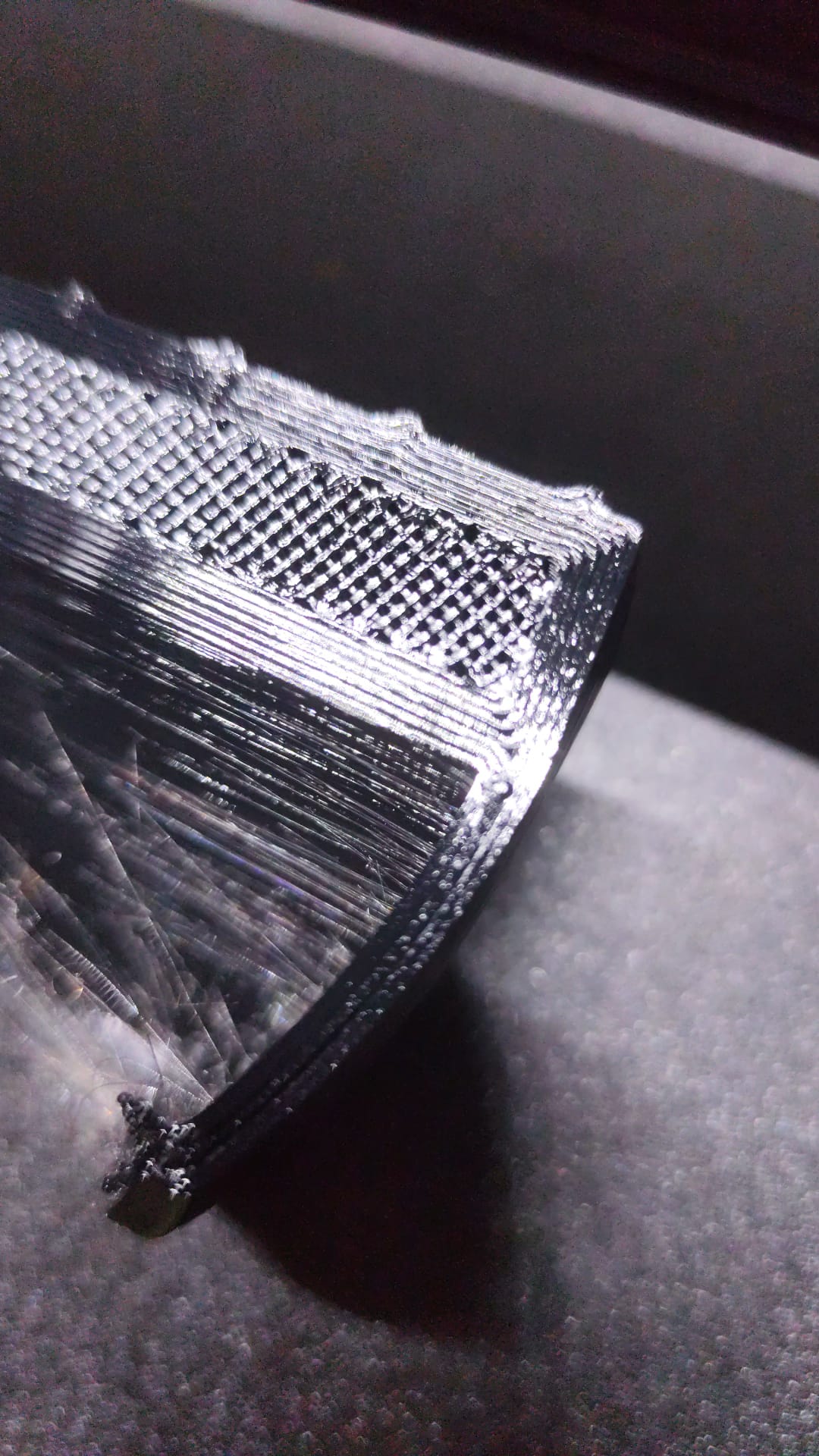 Macro detail of a 3D-printed laminitis horseshoe showing print layers and internal infill